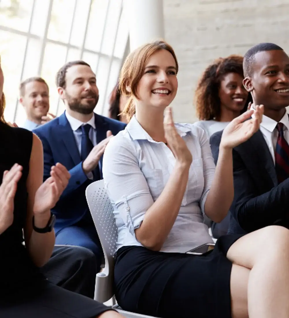 APU Global employees applauding at a community gathering